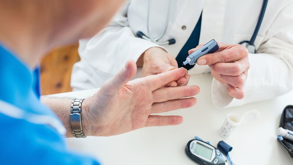 doctor takes blood sugar for diabetes